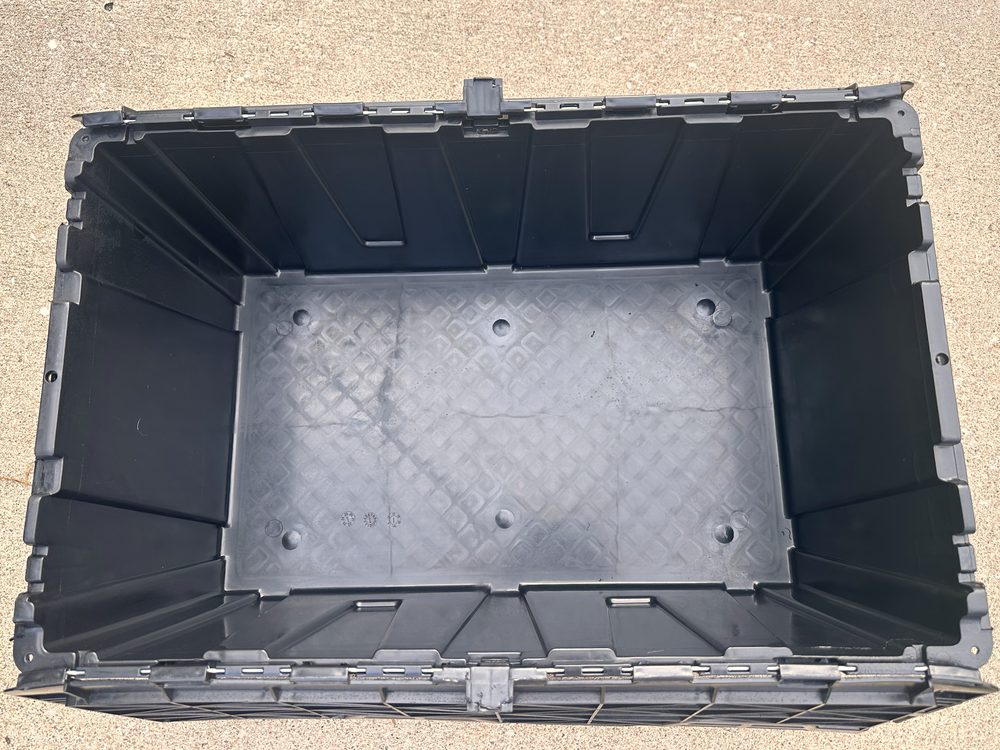 Looking down into an empty JoCo Bin Co moving bin, showing the clean, dry interior floor