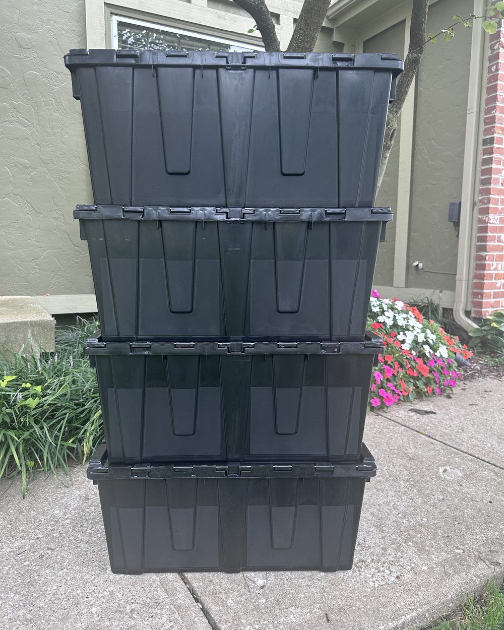 Four JoCo Bin Co moving bins stacked in a square column, lids attached and latched
